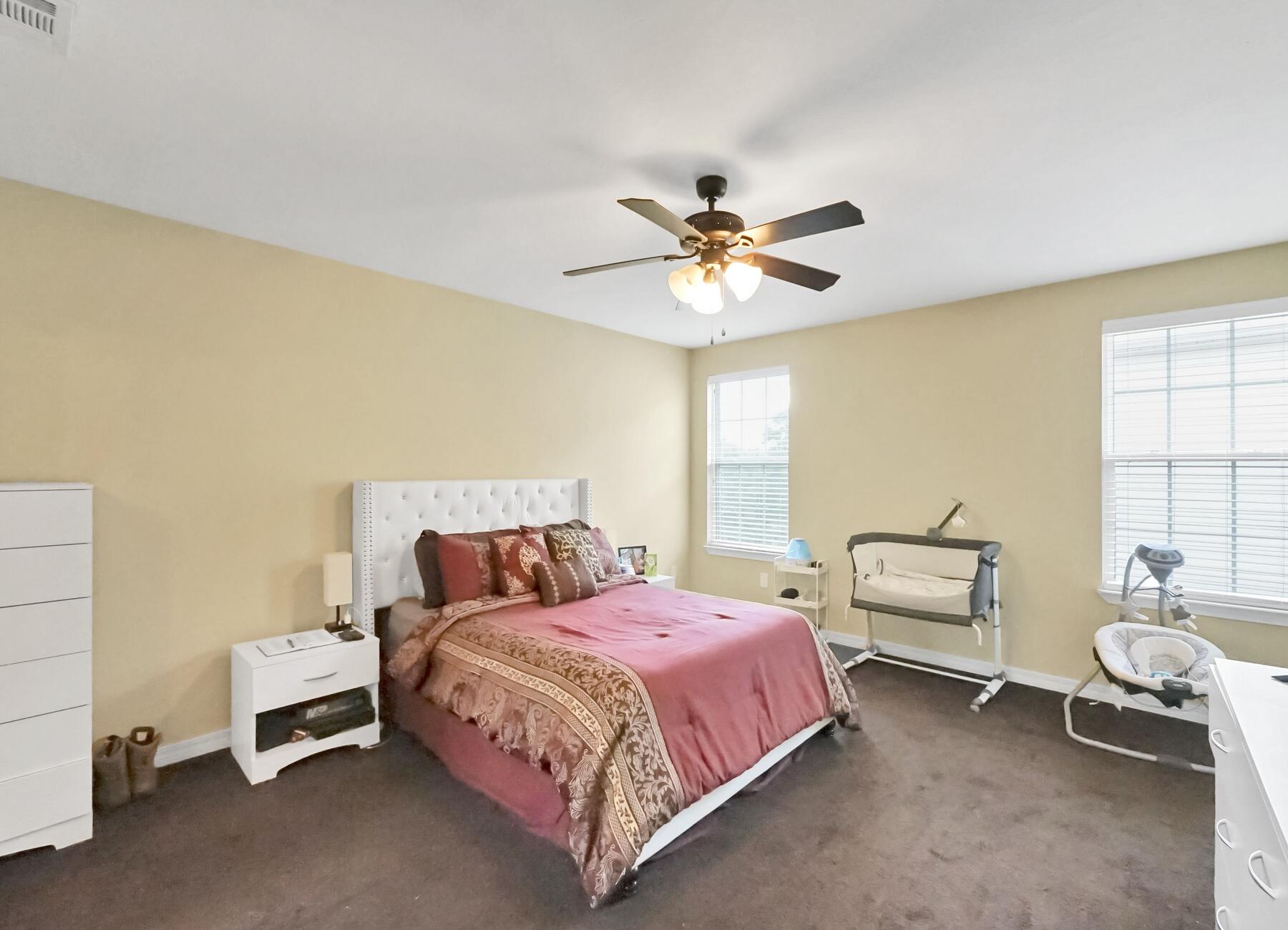 220 Wainwright Drive Crestview, FL 32539 - Photo 27 of 56 a bedroom with a bed and a chandelier