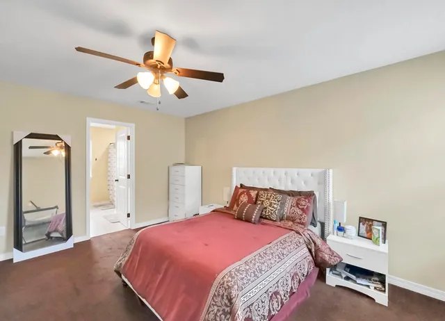 a en suite bathroom with a granite countertop sink and a mirror