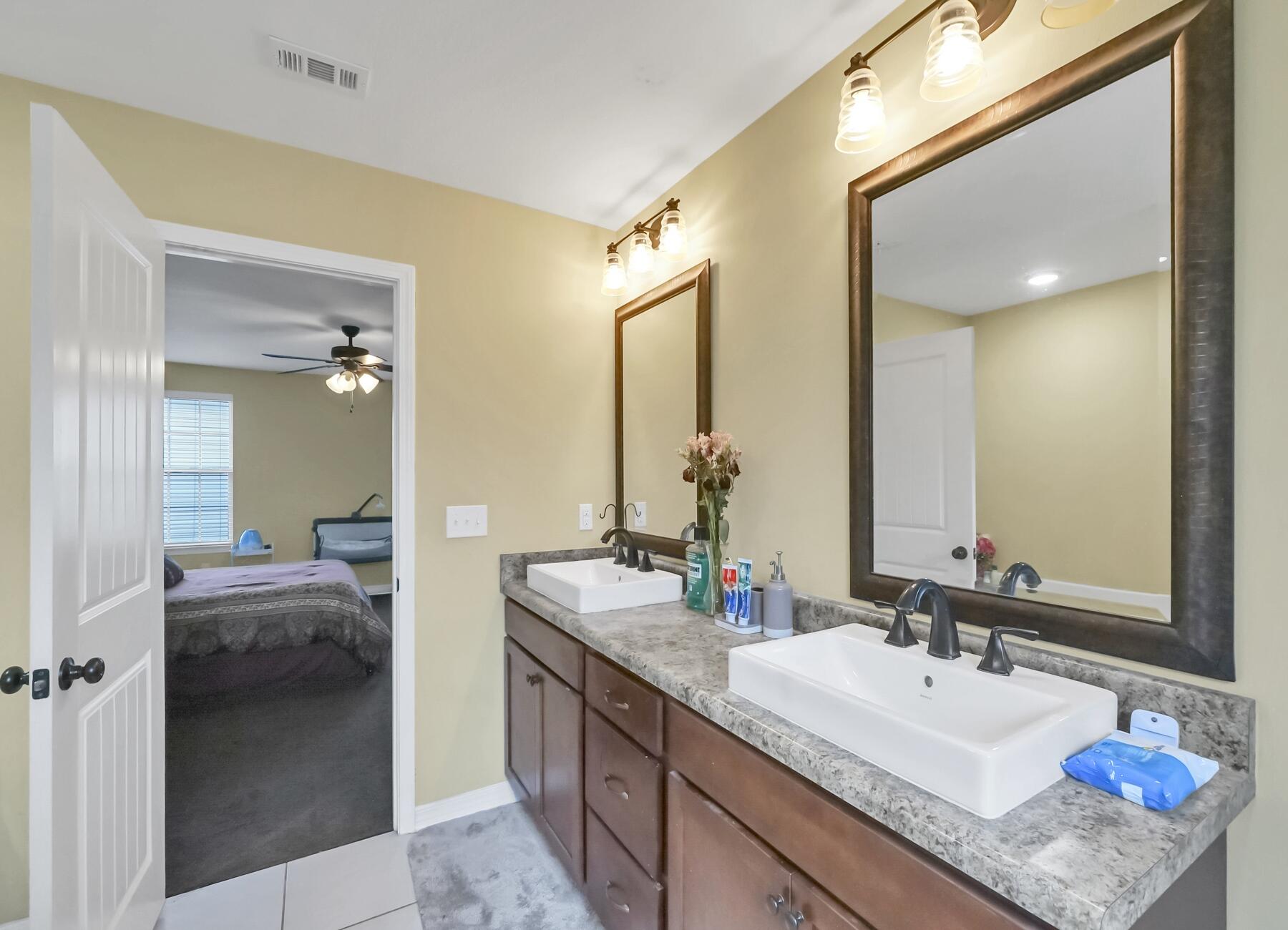 220 Wainwright Drive Crestview, FL 32539 - Photo 31 of 56 a en suite bathroom with a granite countertop sink and a mirror