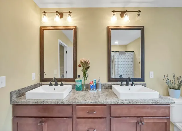 a bathroom with a tub and shower curtain