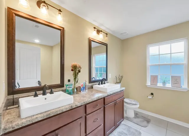 a bathroom with a sink double vanity and a mirror