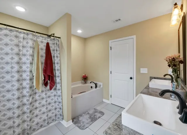 a bathroom with double vanity sinks and a mirror