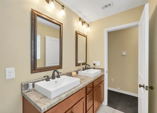 a bedroom with a bed and a flat tv screen on dresser