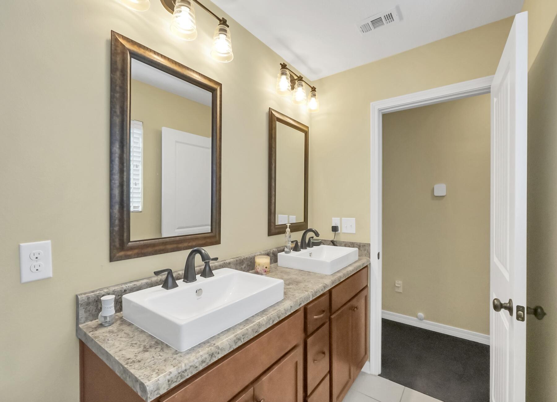 220 Wainwright Drive Crestview, FL 32539 - Photo 36 of 56 a bathroom with a sink double vanity and a mirror