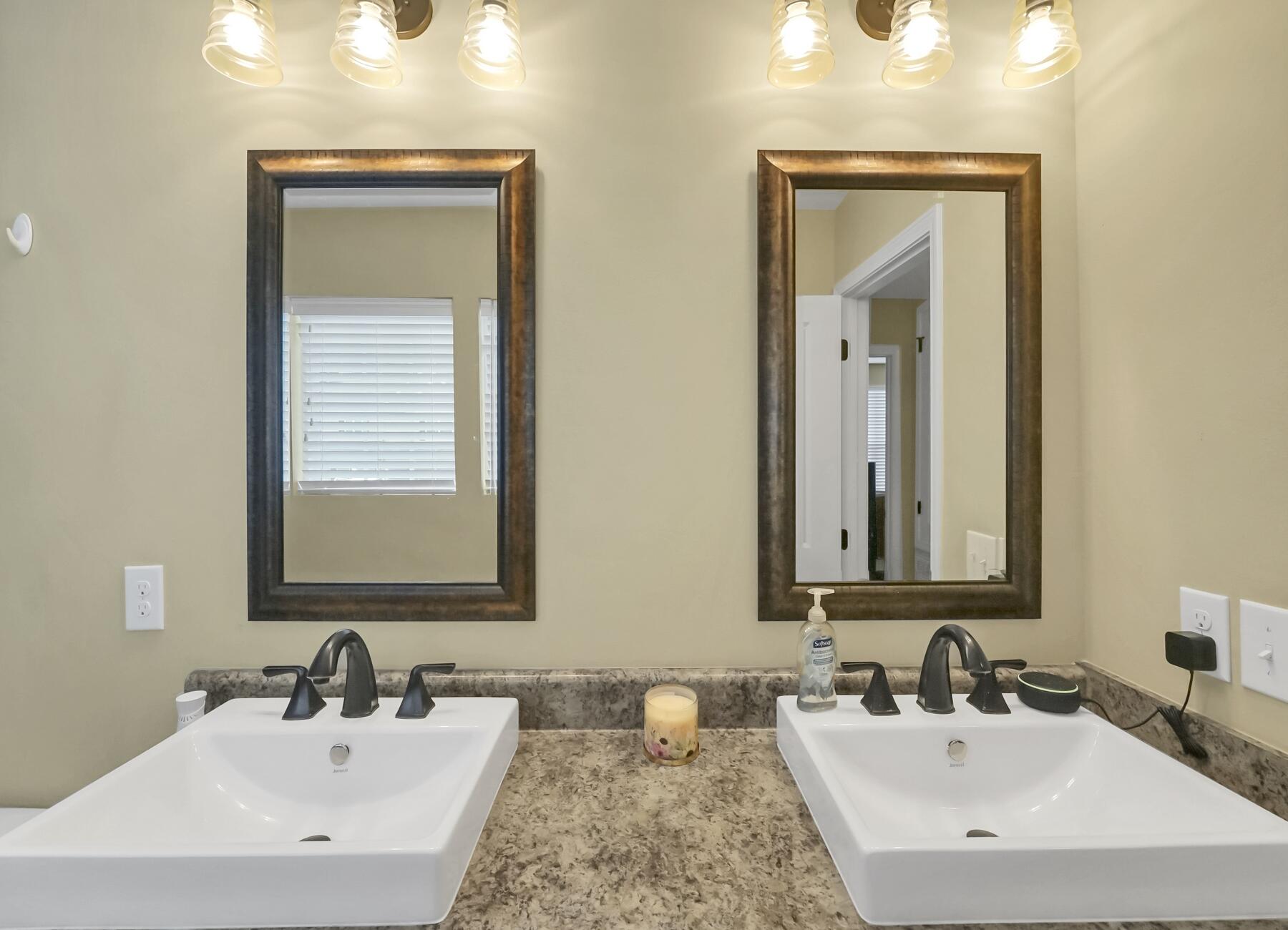 220 Wainwright Drive Crestview, FL 32539 - Photo 38 of 56 a bathroom with double vanity sinks and a mirror