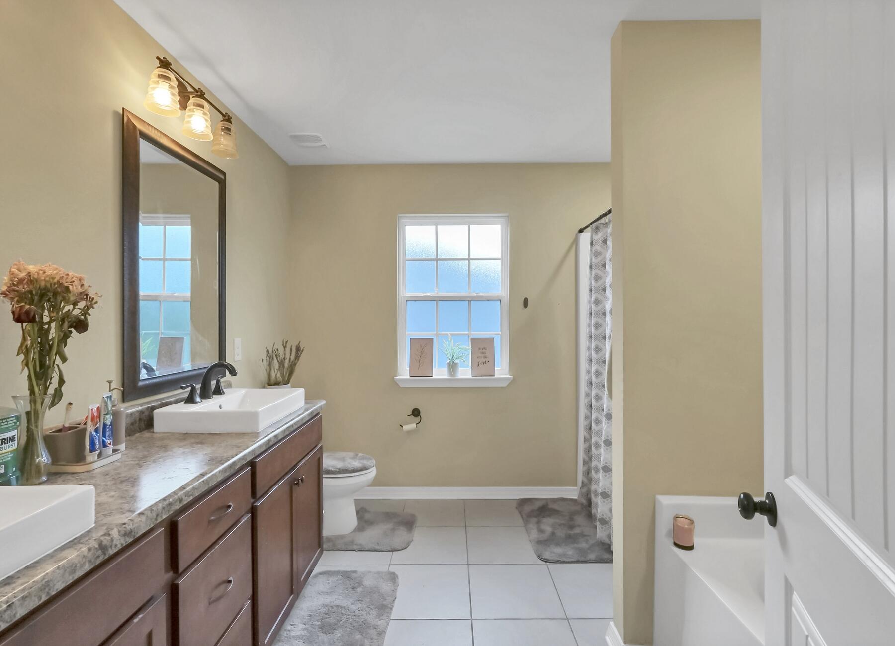 220 Wainwright Drive Crestview, FL 32539 - Photo 45 of 56 a bathroom with a granite countertop sink a toilet and mirror
