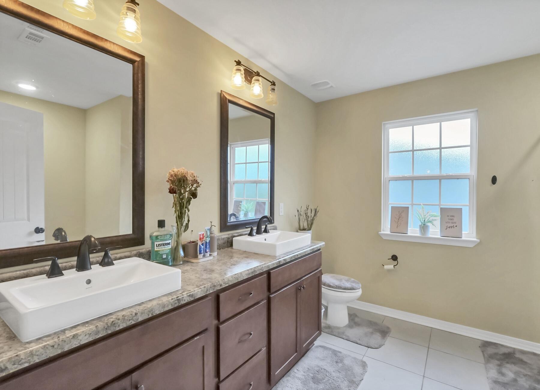 220 Wainwright Drive Crestview, FL 32539 - Photo 46 of 56 a bathroom with double sink and a mirror