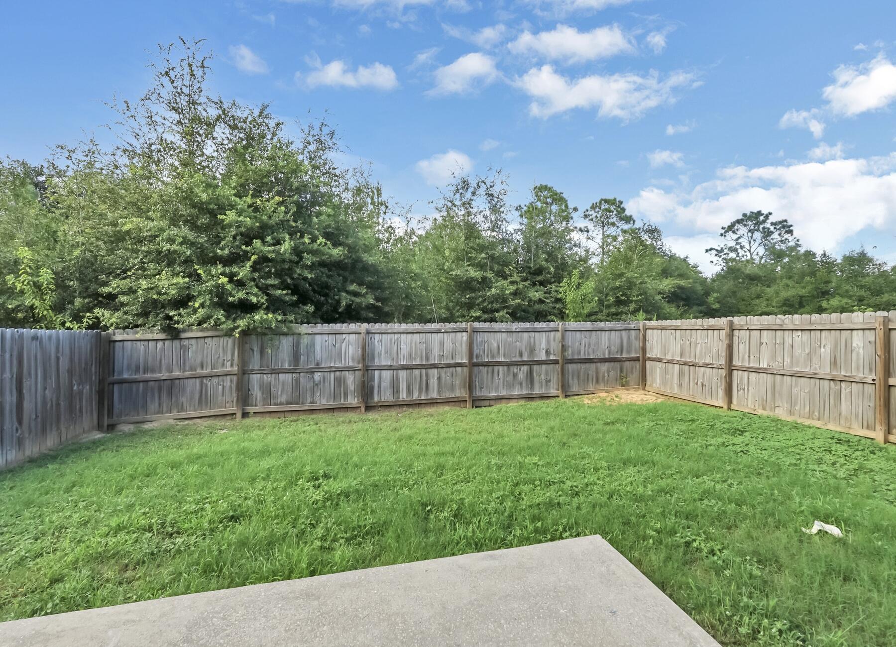 220 Wainwright Drive Crestview, FL 32539 - Photo 55 of 56 a view of a backyard with a wooden fence