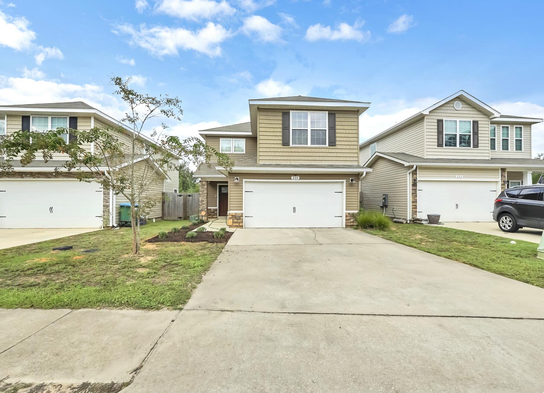 220 Wainwright Drive Crestview, FL 32539 - Photo 7 of 56 a view of a white house with a yard and plants