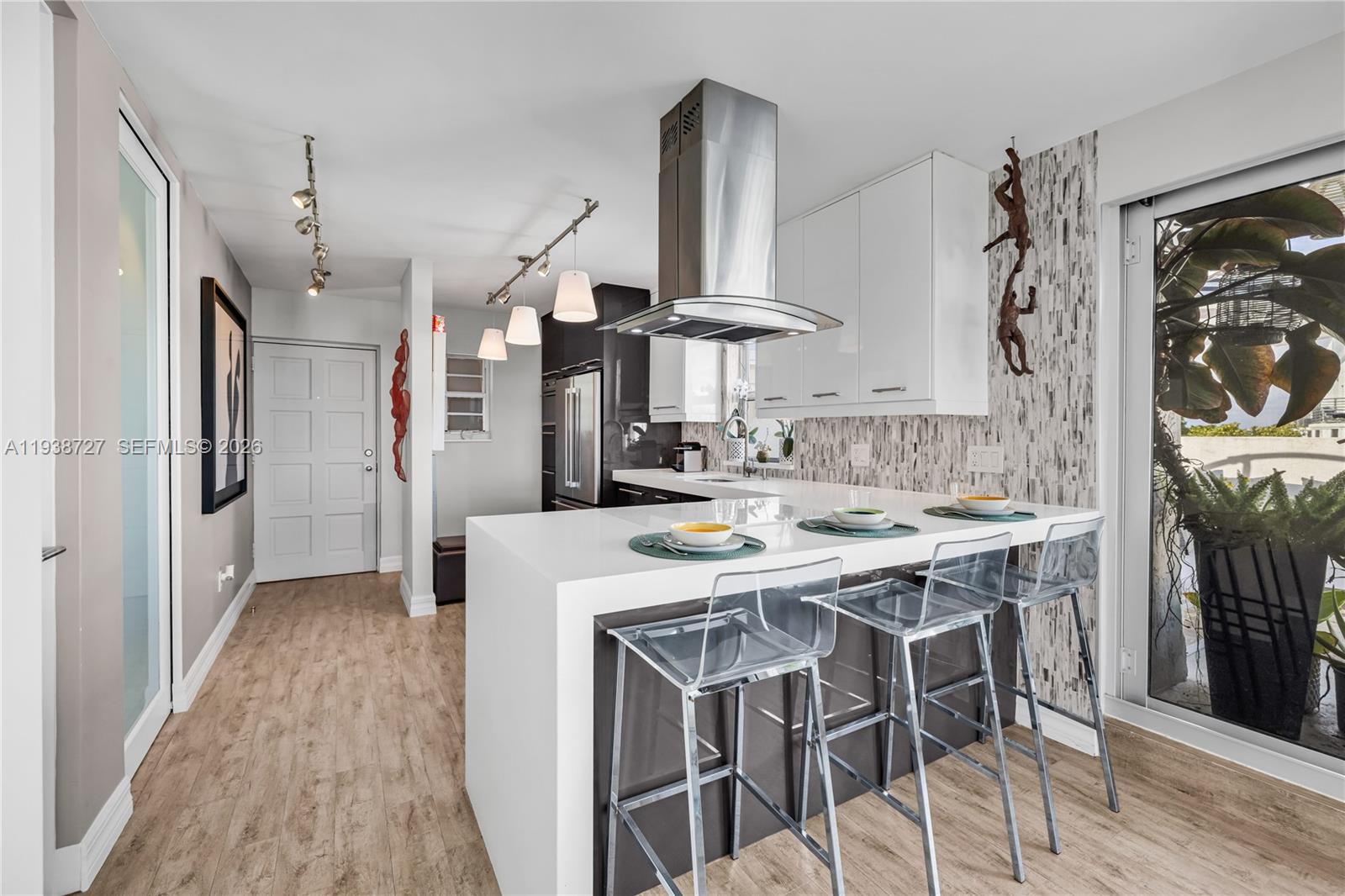 a kitchen with stainless steel appliances a stove a sink dishwasher and a refrigerator