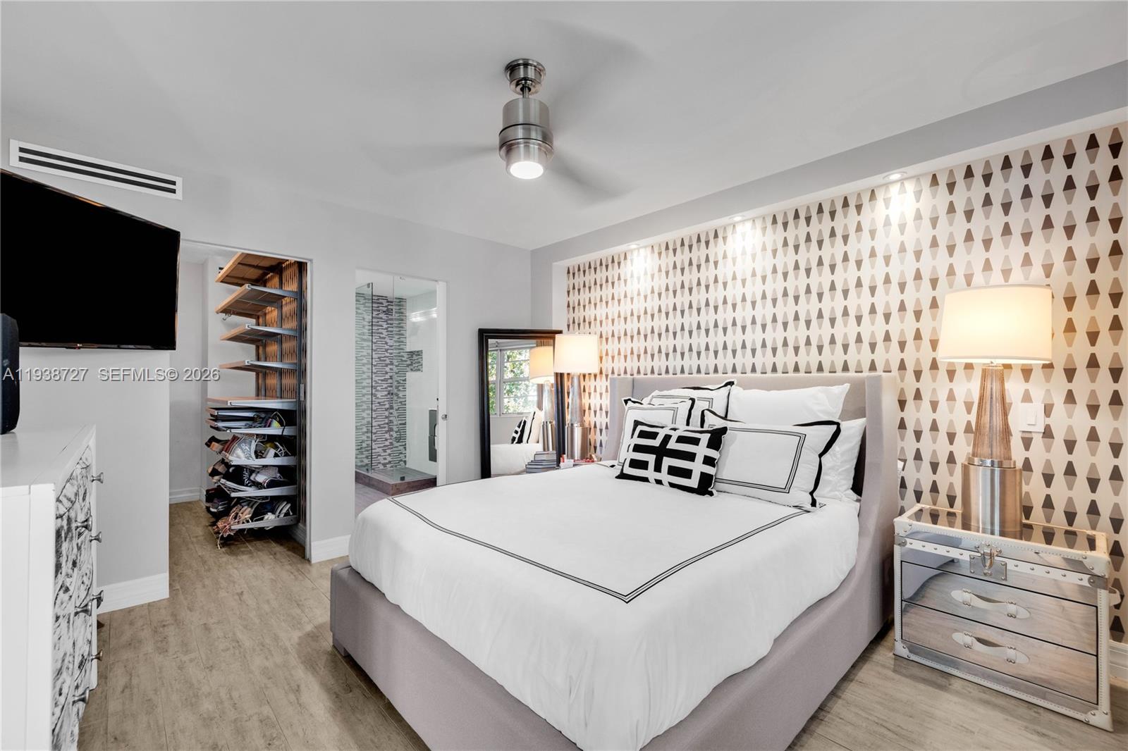 680 Northeast 64th Street, Unit APH3 Miami, FL 33138 - Photo 13 of 38 a bedroom with a large bed and a flat tv screen