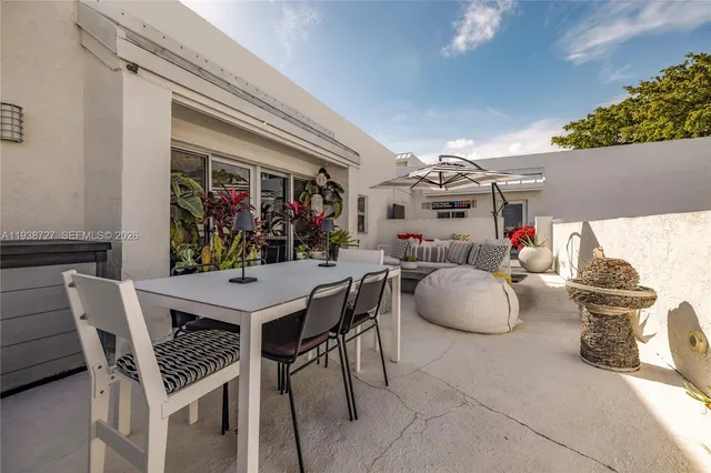 a view of a dining room with furniture and a potted plant