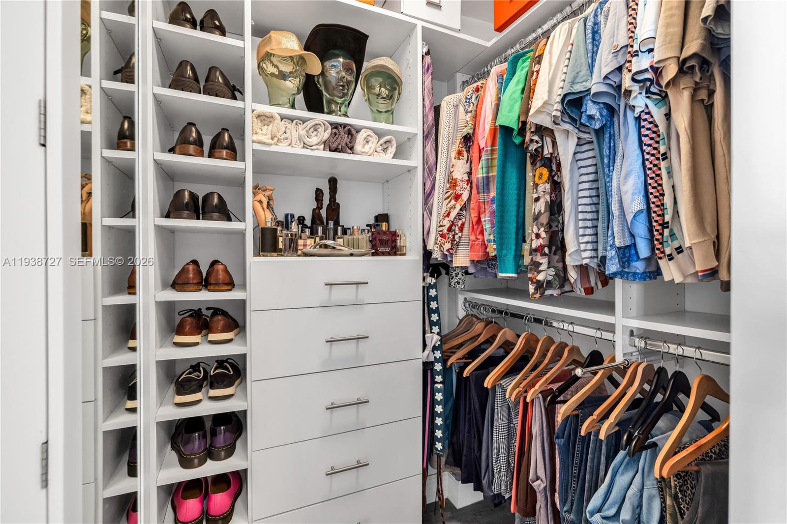 680 Northeast 64th Street, Unit APH3 Miami, FL 33138 - Photo 7 of 38 a view of walk in closet with clothes and shoes