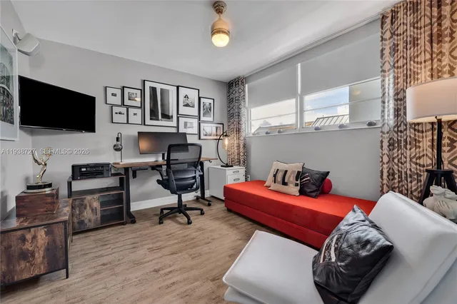 a bedroom with furniture and a flat screen tv
