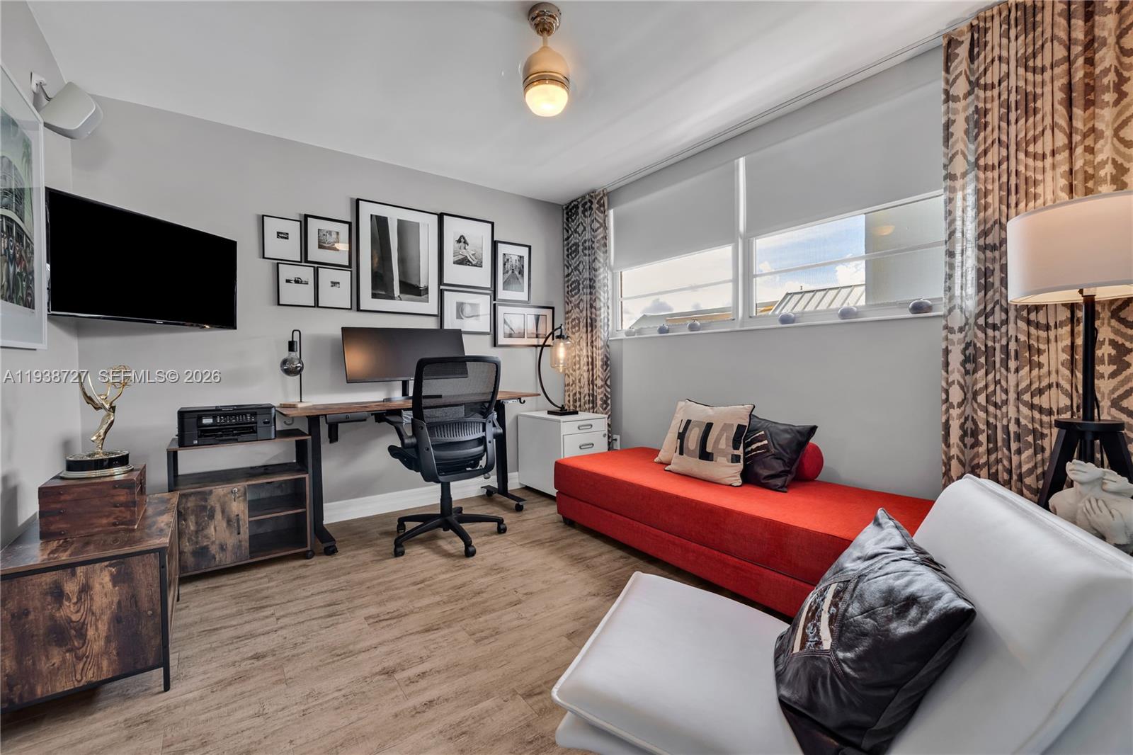 680 Northeast 64th Street, Unit APH3 Miami, FL 33138 - Photo 8 of 38 a bedroom with furniture and a flat screen tv