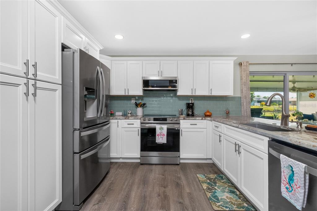 219 Caddy Road Rotonda West, FL 33947 - Photo 17 of 89 a kitchen with a refrigerator stove and sink