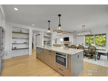 a kitchen with stainless steel appliances kitchen island granite countertop a sink and cabinets