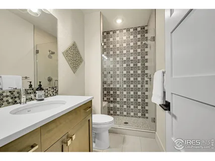 a bedroom with a bed and a night stand