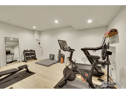 a living room with patio furniture and a potted plant