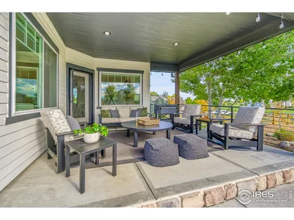 a view of a patio with dining table and chairs with a small yard