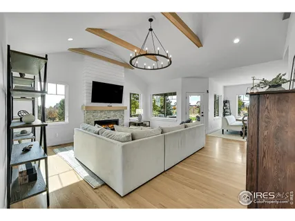 a living room with lots of furniture and kitchen view