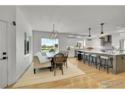a kitchen with kitchen island a stove a table and chairs in it