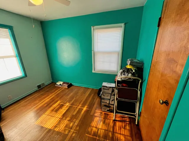 a bed sitting in a room next to a window