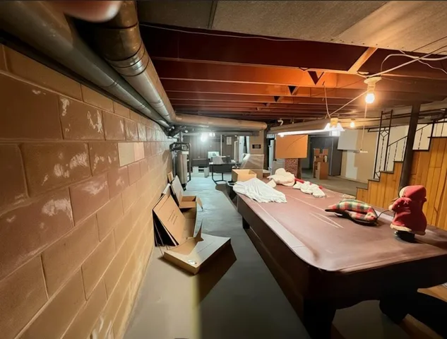 a room with gym equipment and a chandelier