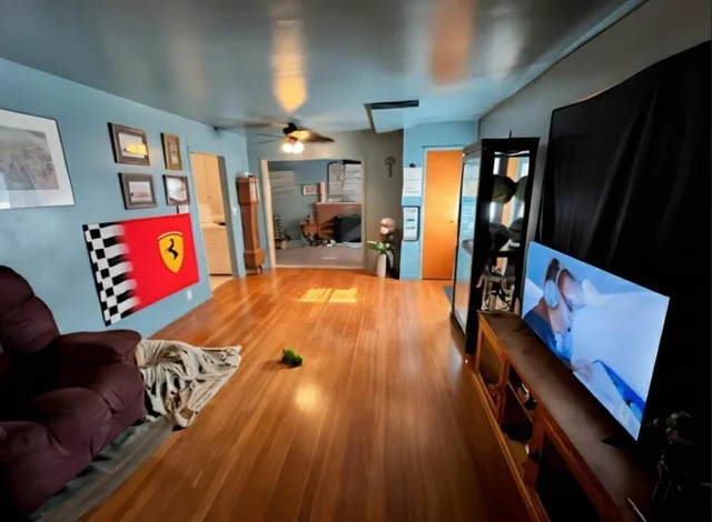 a view of a living room with furniture and a flat screen tv