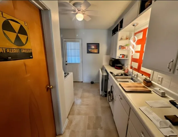 a kitchen with sink a stove and refrigerator