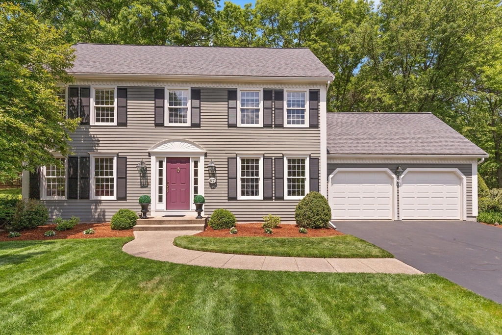 a front view of a house with a yard and garage