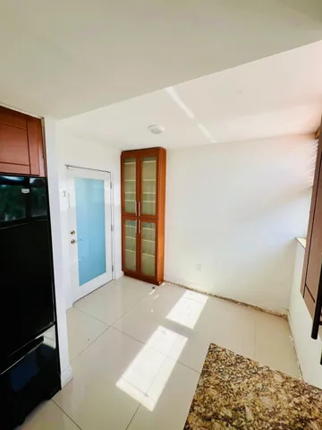 a view of an empty room and a window