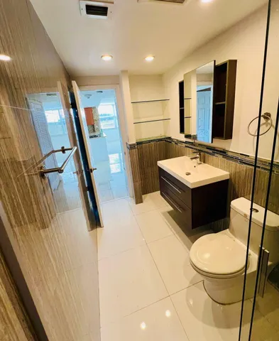 a bathroom with a sink a toilet a mirror and vanity