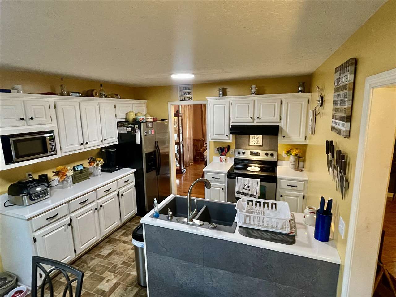 315 Rich Road Savannah, TN 38372 - Photo 2 of 20 a kitchen with stainless steel appliances a stove a refrigerator a sink a counter space and cabinets