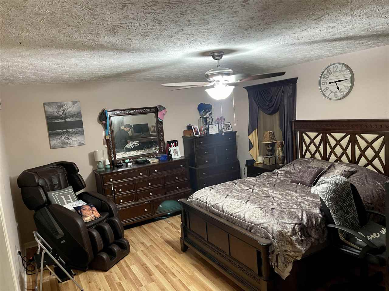315 Rich Road Savannah, TN 38372 - Photo 8 of 20 a bedroom with a bed and wooden floor