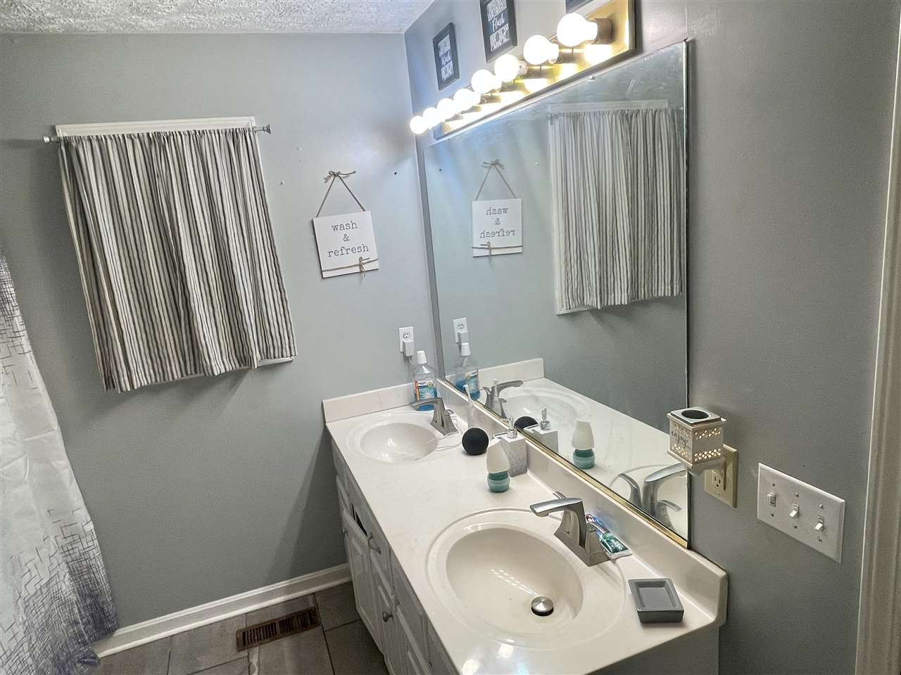 315 Rich Road Savannah, TN 38372 - Photo 9 of 20 a bathroom with a sink a mirror and vanity