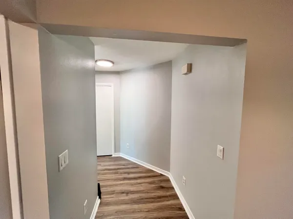 a view of a hallway with wooden floor
