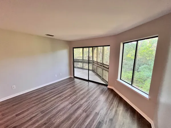 wooden floor in an empty room with a window