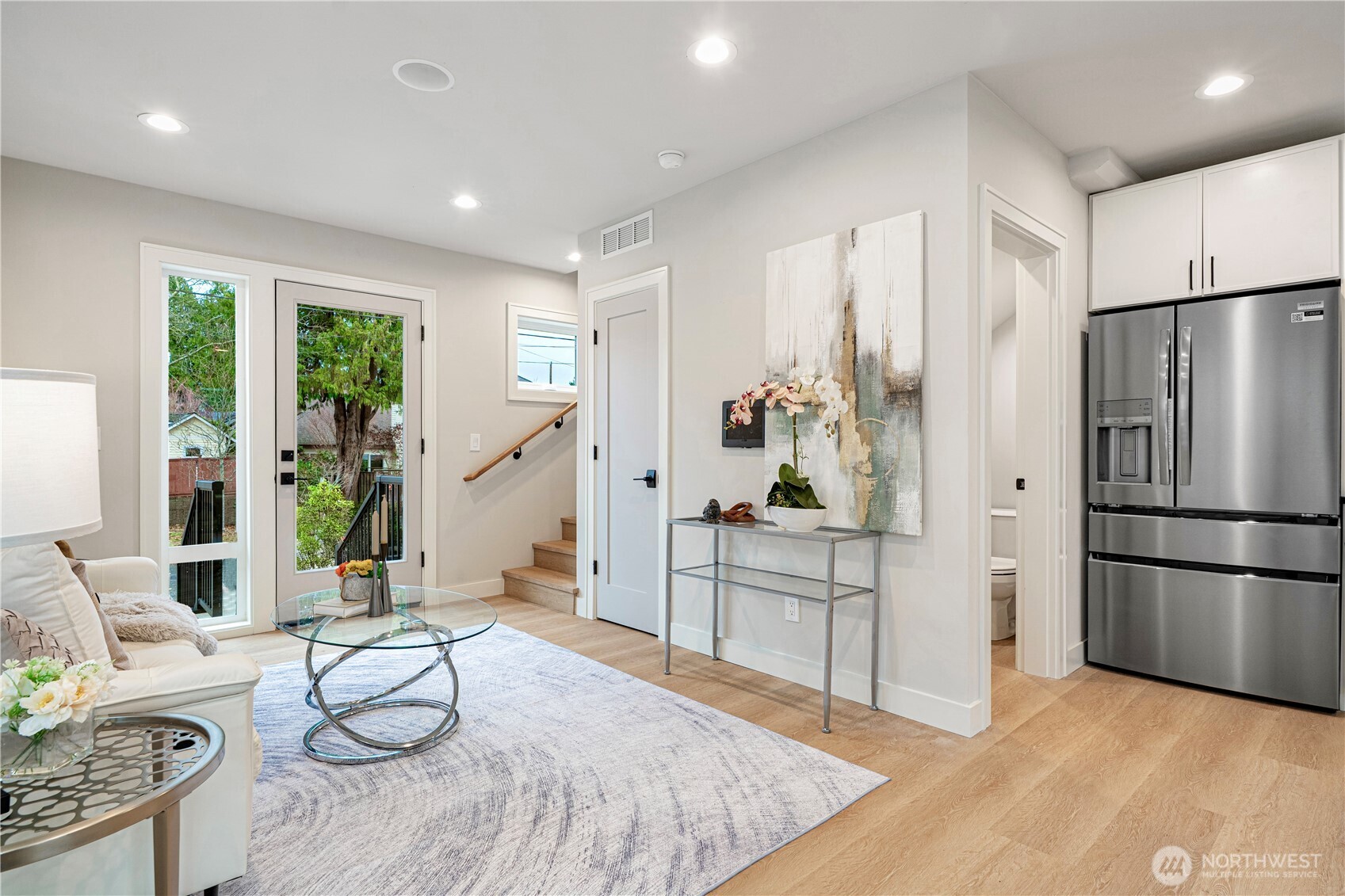 3054 Fairmount Avenue Southwest Seattle, WA 98116 - Photo 4 of 18 a large white kitchen with stainless steel appliances granite countertop a refrigerator and a stove top oven