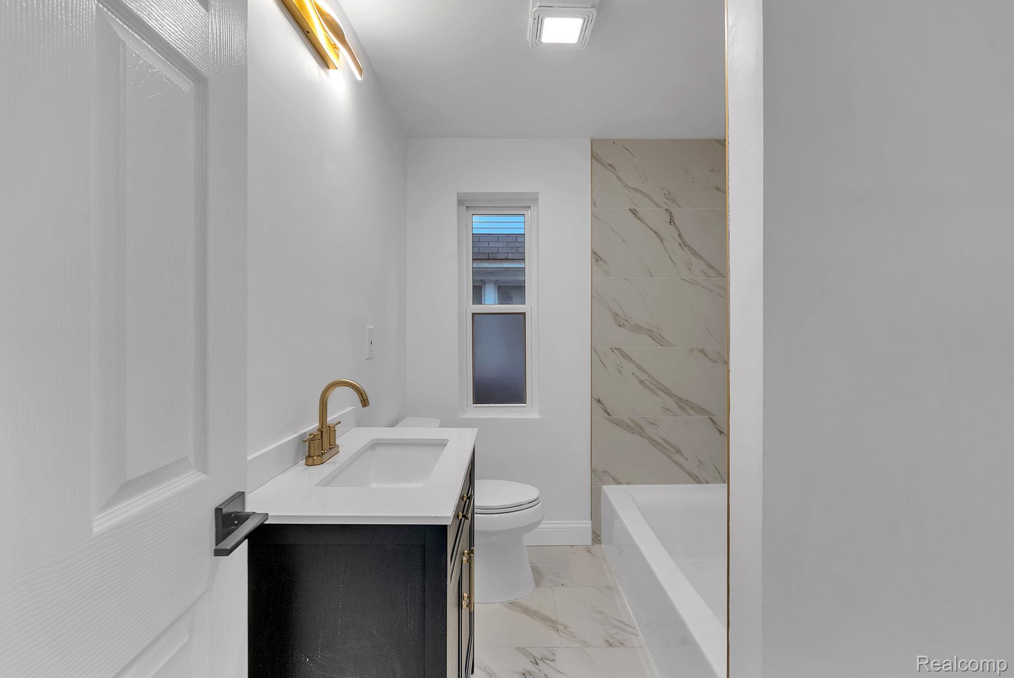 4113 Devonshire Road Detroit, MI 48224 - Photo 14 of 36 Full bathroom featuring vanity and light marble finish floors