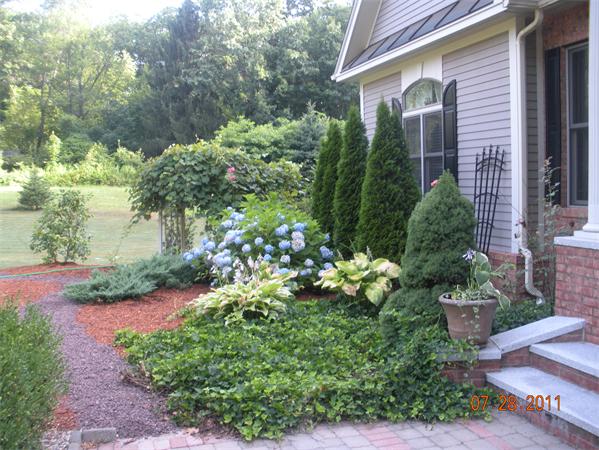 Lot 8 Florence Road Northampton, MA 01062 - Photo 8 of 30 a front view of a house with a yard and potted plants