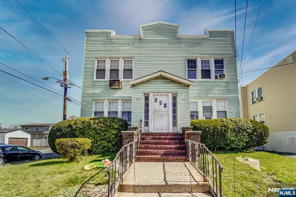 102 Exton Avenue North Arlington, NJ 07031 - Photo 1 of 18 a front view of a house with garden
