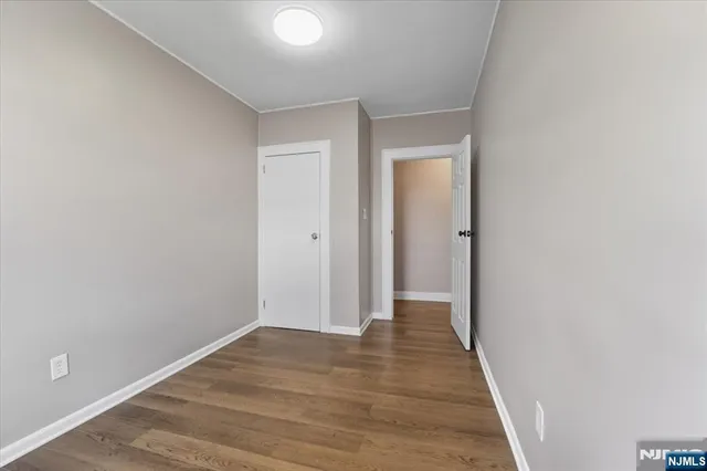 a view of hallway with wooden floor