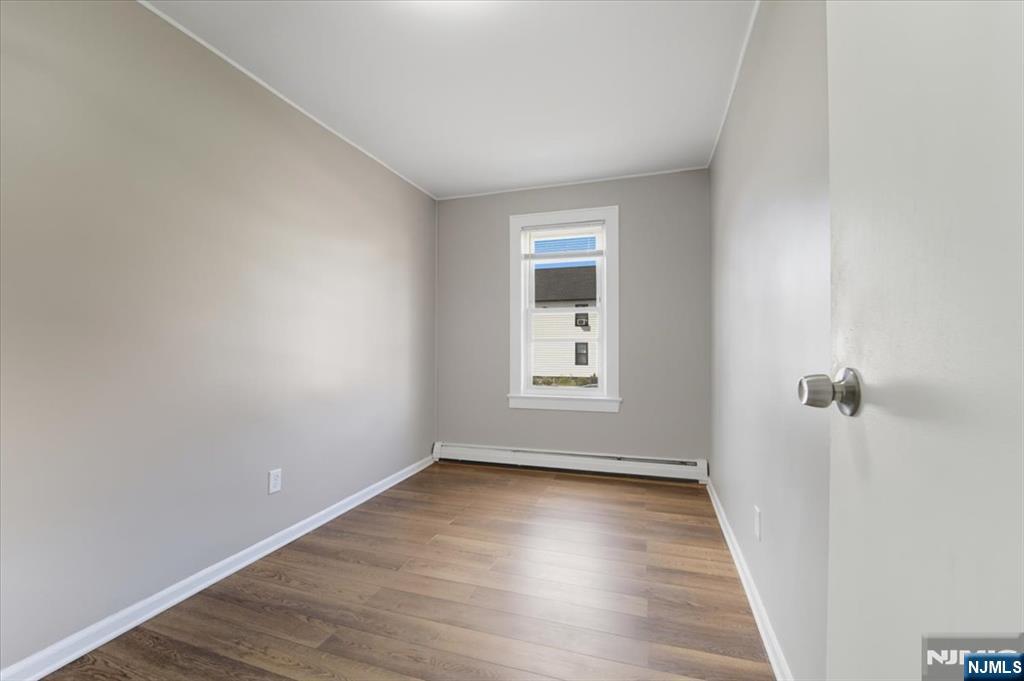 102 Exton Avenue North Arlington, NJ 07031 - Photo 14 of 18 wooden floor in an empty room with a window