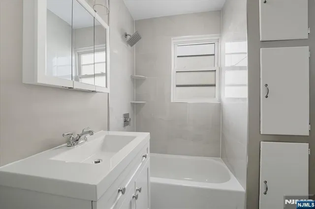 a white bath tub sitting next to a white sink