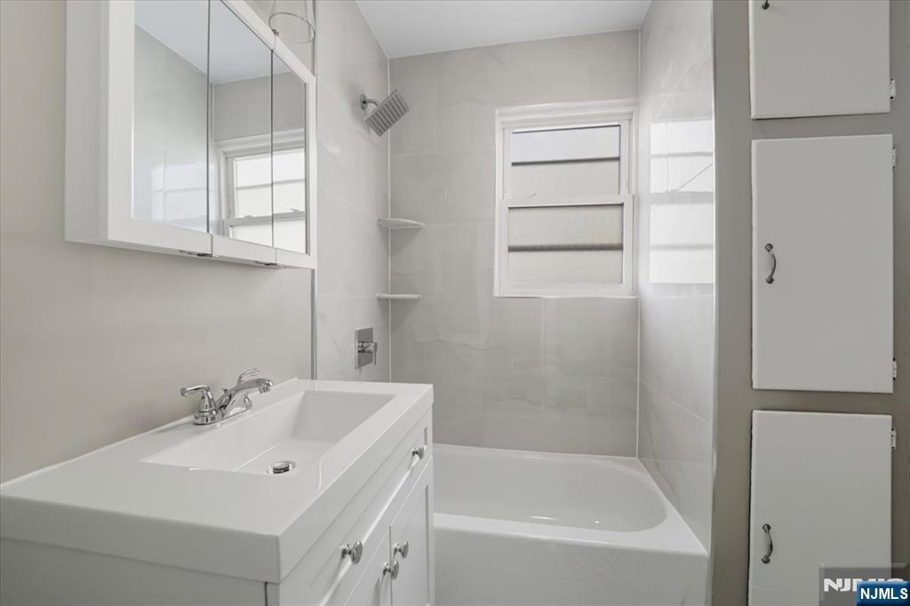 102 Exton Avenue North Arlington, NJ 07031 - Photo 16 of 18 a white bath tub sitting next to a white sink