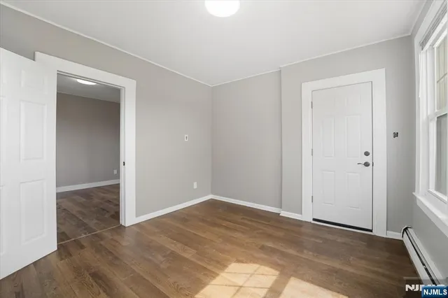 an empty room with wooden floor