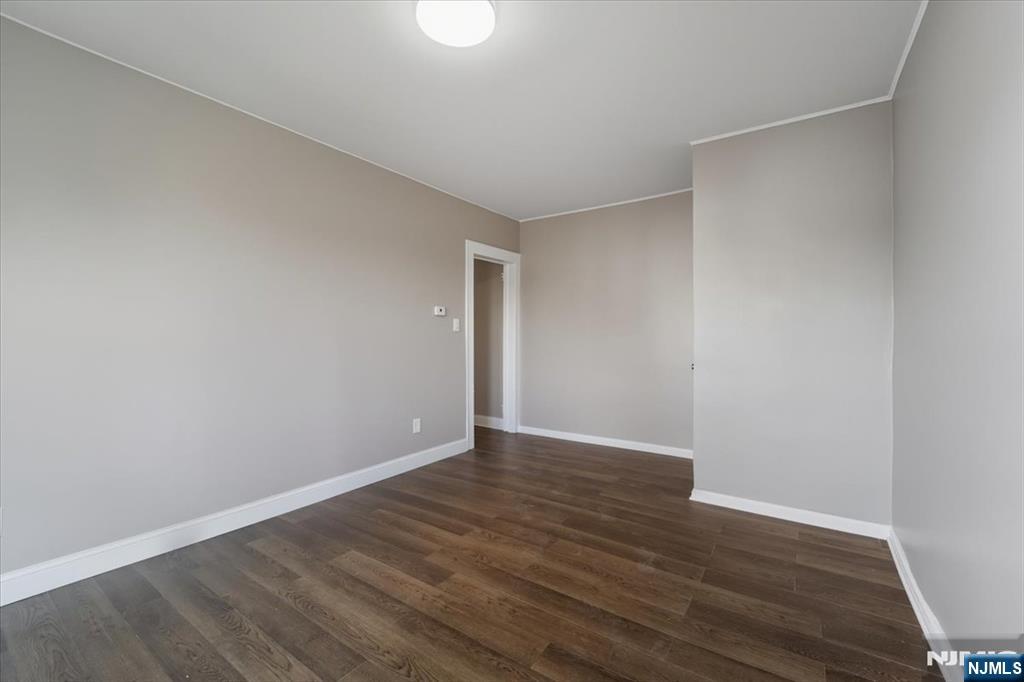 102 Exton Avenue North Arlington, NJ 07031 - Photo 5 of 18 a view of an empty room with wooden floor