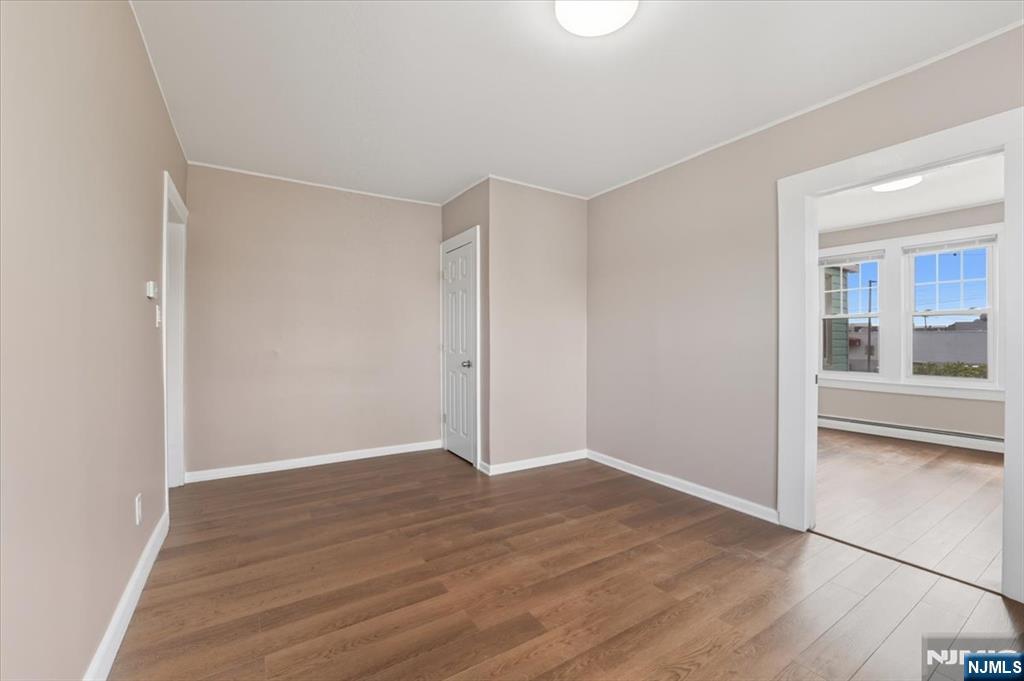 102 Exton Avenue North Arlington, NJ 07031 - Photo 7 of 18 a view of an empty room with wooden floor