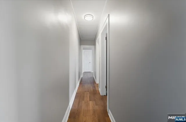 a view of hallway with wooden floor